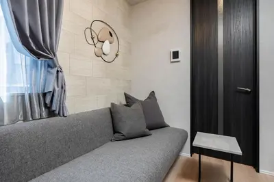 a living room with a couch and a window at Bijou Suites Zephyr in Tokyo