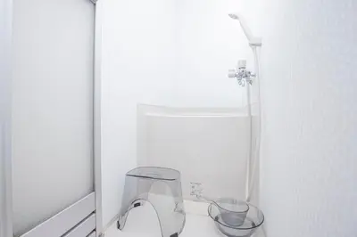 a bathroom with a pair of shoes and a mirror at Tokyo Ikebukuro apartment near Pokemon Center in Wada