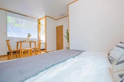 a large bed in a room with a table at Tokyo Ikebukuro apartment near Pokemon Center in Wada