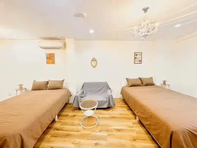 two beds in a room with wooden floors at Opening in December ,Riverside stay,to Narita Airport ,Shinjuku in Tokyo