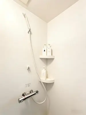 a shower in a bathroom with white walls at Opening in December ,Riverside stay,to Narita Airport ,Shinjuku in Tokyo