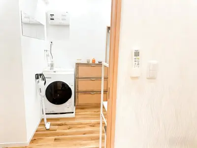 a laundry room with a washing machine and a ladder at Opening in December ,Riverside stay,to Narita Airport ,Shinjuku in Tokyo