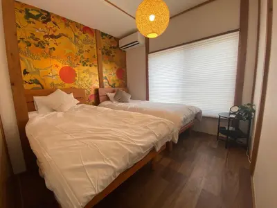 a bedroom with two twin beds and a window at Takara Entire Japanese house with a view of the shrine in Tokyo