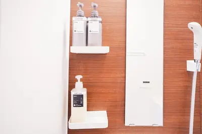 a bathroom with two bottles of soap and a mirror at Takara Entire Japanese house with a view of the shrine in Tokyo