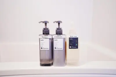 two bottles ofodorizers are sitting on a shelf at Takara Entire Japanese house with a view of the shrine in Tokyo