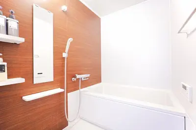 a bathroom with a tub and a sink and a mirror at Takara Entire Japanese house with a view of the shrine in Tokyo