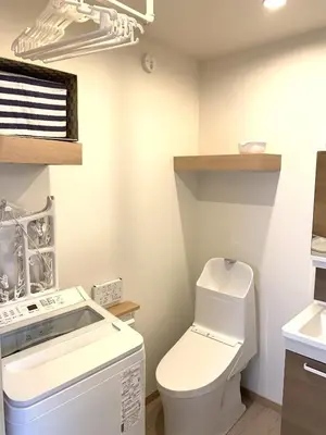 a bathroom with a toilet and a sink at Wing Stay in Tokyo