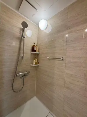 a bathroom with a shower with a shower head at Wing Stay in Tokyo