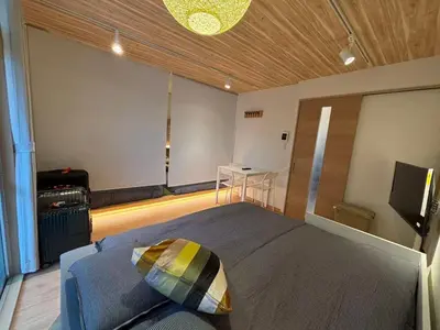 a bedroom with a bed and a table in a room at Wing Stay in Tokyo