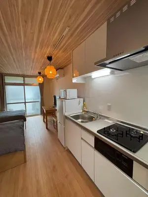 a kitchen with a sink and a stove top oven at Wing Stay in Tokyo