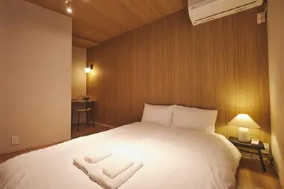 a bedroom with a large white bed with two pillows at Ebisu2 Lux Villa 6 min Shibuya 4min Ebisu in Tokyo