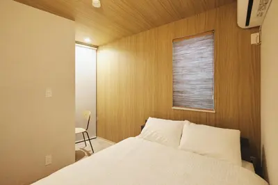 a bedroom with a white bed and a window at Ebisu2 Lux Villa 6 min Shibuya 4min Ebisu in Tokyo