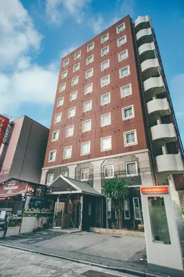 a tall red building on the side of a street at Kuretake-Inn Tokyo Funabori in Tokyo