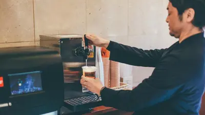 a man is making a drink in a machine at Kuretake-Inn Tokyo Funabori in Tokyo