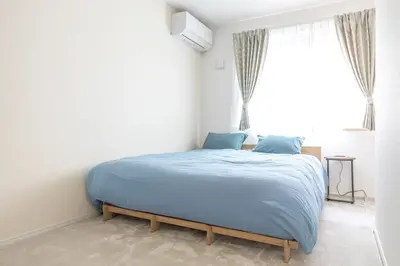 a bedroom with a blue bed with a window at Featured Japanese Culture Hut Experience Tokyo's Local Life in a Two-Story Detached B&B in Tokyo