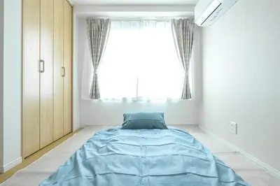 a bedroom with a large blue bed in front of a window at Featured Japanese Culture Hut Experience Tokyo's Local Life in a Two-Story Detached B&B in Tokyo
