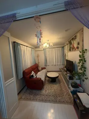 a living room with a couch and a tv at sakura\u306e\u5bb6 in Tokyo