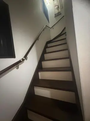 a staircase in a house with wooden floors and a stair railing at sakura\u306e\u5bb6 in Tokyo