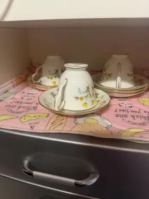 a shelf with three tea cups and saucers on it at sakura\u306e\u5bb6 in Tokyo