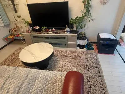 a living room with a large television and a table at sakura\u306e\u5bb6 in Tokyo