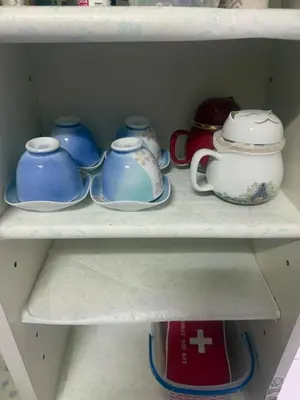 a shelf filled with blue and white pots and pans at sakura\u306e\u5bb6 in Tokyo