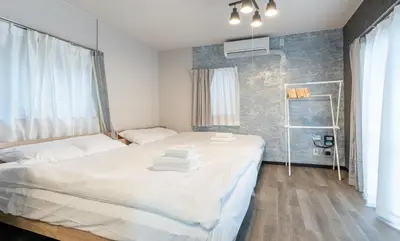a bedroom with a bed with towels on it at Marble TOKYO Base Tabata 102 in Tokyo