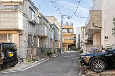 a black car parked on a street with buildings at Marble TOKYO Base Tabata 102 in Tokyo