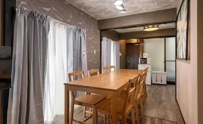 a dining room with a wooden table and chairs at Marble TOKYO Base Tabata 202 in Tokyo