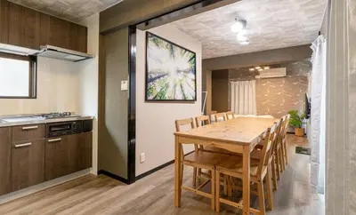 a kitchen and dining room with a wooden table and chairs at Marble TOKYO Base Tabata 202 in Tokyo
