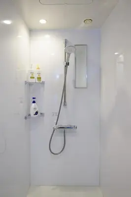 a shower in a bathroom with a glass door at Ebisu City Stay 5F - \u6075\u6bd4\u5bff \u30b7\u30c6\u30a3\u30b9\u30c6\u30a4 5F in Tokyo