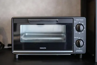a black toaster oven sitting on top of a counter at Ebisu City Stay 5F - \u6075\u6bd4\u5bff \u30b7\u30c6\u30a3\u30b9\u30c6\u30a4 5F in Tokyo