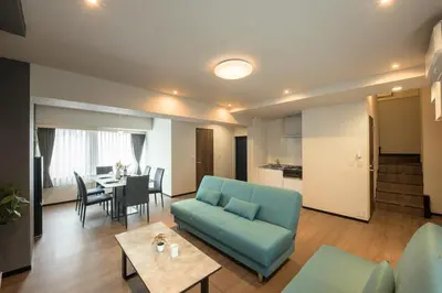 a living room with a blue couch and a table at Ebisu City Stay 5F - \u6075\u6bd4\u5bff \u30b7\u30c6\u30a3\u30b9\u30c6\u30a4 5F in Tokyo