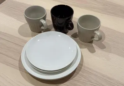 three cups and plates on a wooden table at Marble TOKYO Base Tabata 201 in Tokyo