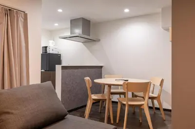 a kitchen with a table and chairs in a room at Marble TOKYO Base Tabata 201 in Tokyo