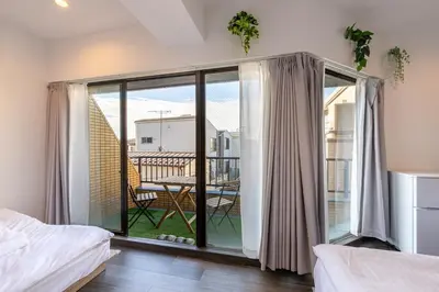 a bedroom with a large window and a balcony at Marble TOKYO Base Tabata 301 in Tokyo