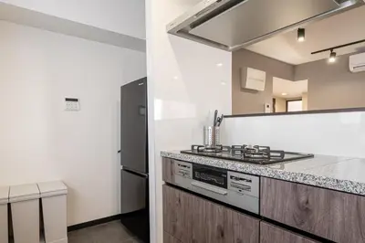 a kitchen with a stove and a counter top at Marble TOKYO Base Tabata 301 in Tokyo