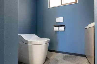 a bathroom with a white toilet in a blue wall at Marble TOKYO Base Tabata 301 in Tokyo
