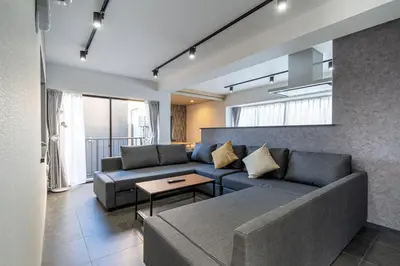 a living room with a couch and a table at Marble TOKYO Base Tabata 301 in Tokyo