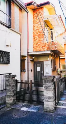 a house with a black fence and a gate at Real Japanese Culture Stay Shibamata Near Asakusa in Tokyo
