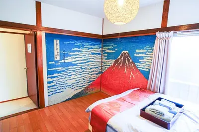 a bedroom with a painting of a mountain on the wall at Real Japanese Culture Stay Shibamata Near Asakusa in Tokyo