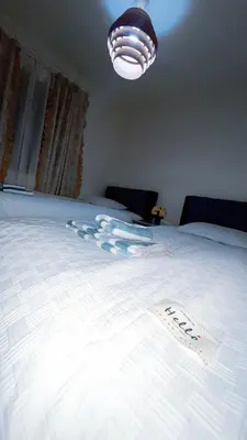 a large white bed with a sign on it at Tokyo Hoshino House 1Floor in Tokyo