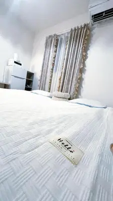 a white bed with a sign on top of it at Tokyo Hoshino House 1Floor in Tokyo