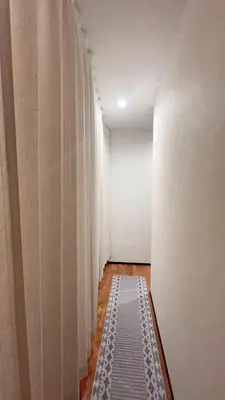 a hallway with white curtains and a rug at Tokyo Hoshino House 1Floor in Tokyo
