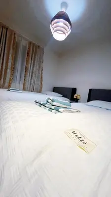 a white bed with a sign on top of it at Tokyo Hoshino House 1Floor in Tokyo