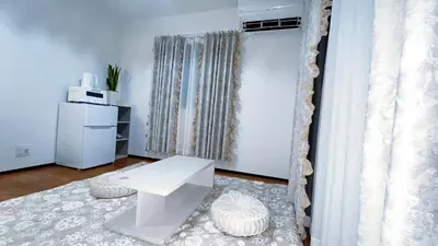 a living room with a white table and a window at Tokyo Hoshino House 1Floor in Tokyo