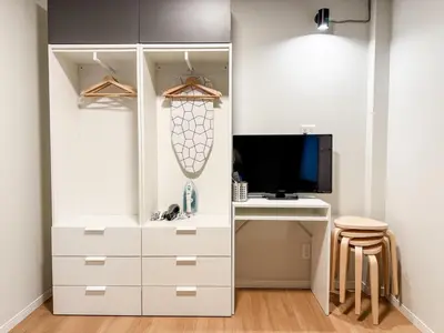 a white closet with a desk and a television at 2F TINY Central Apartment 7 minutes from Shinjuku in Tokyo