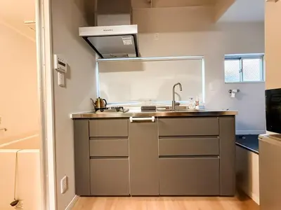 a kitchen with a sink and a stove at 2F TINY Central Apartment 7 minutes from Shinjuku in Tokyo