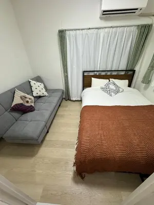 a bedroom with a bed and a couch at 5 minutes on foot from Otsuka Station on the Yamanote Line, with excellent access to major areas such as Ikebukuro, Shinjuku, and Ueno! in Tokyo