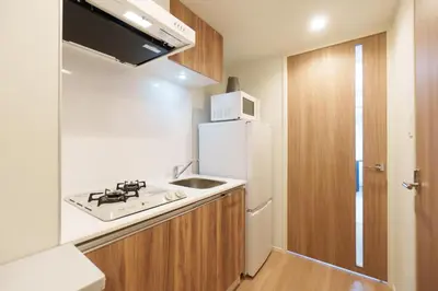 a small kitchen with a sink and a refrigerator at Hotel ONE in Tokyo