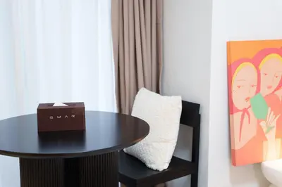 a table in a room with a pillow and a picture at Hotel ONE in Tokyo